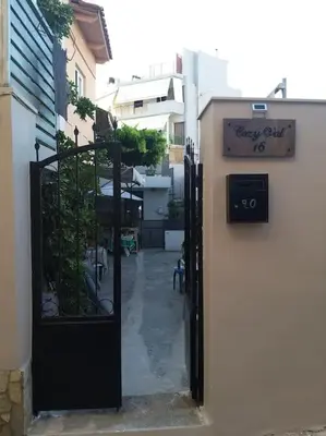 a door to a building with a sign on it at Cozy Val in Chania Town