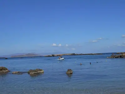 a large body of water with a boat in it at Cozy Val in Chania Town