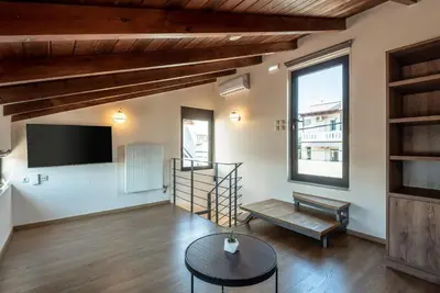 a living room with a tv and a table at Phaedra by PosarelliVillas in Kounoupidhianá