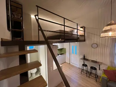 a loft apartment with a staircase and a living room at m&m's city loft in Chania Town