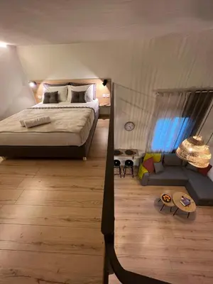 a bedroom with a large bed and a couch at m&m's city loft in Chania Town