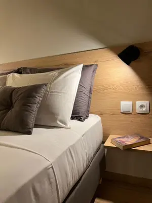 a bedroom with a bed with pillows and a table at m&m's city loft in Chania Town