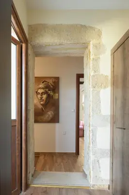 a hallway with a painting of a man on the wall at Nicole Villa I 