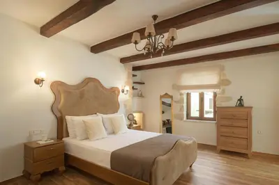 a bedroom with a large bed with a wooden headboard at Nicole Villa I 