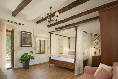 a bedroom with a canopy bed and a couch at Nicole Villa I 
