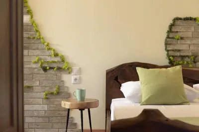 a bedroom with a bed and a brick wall at Nicole Villa I 