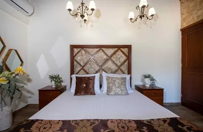 a bedroom with a bed with white sheets and pillows at Geroulios Kastro Villas I 