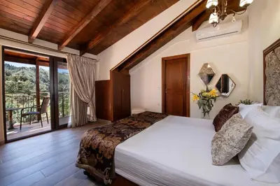 a bedroom with a large bed and a balcony at Geroulios Kastro Villas I 