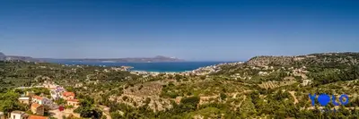 a view of a town on a hill with the ocean at Villa YOLO in Almirida
