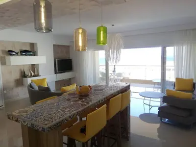 a kitchen and living room with a table and chairs at W Apartment in Chania Town