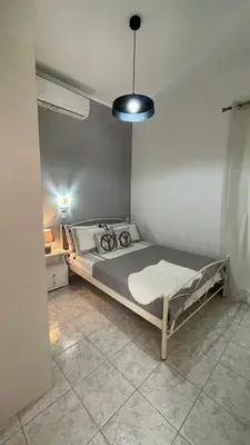 a bedroom with a bed and a blue light at Gesthimani's Residence in Áyios Yeóryios