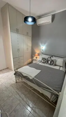 a bedroom with a large bed in a room at Gesthimani's Residence in Áyios Yeóryios
