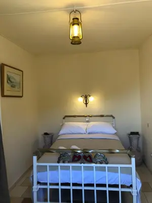 a bedroom with a bed in a room at ARETI Sea View Mountain Cottage in AmigdhalokeFálion