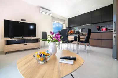 a living room with a vase of flowers on a table at Home Sweet Home - Big Balcony with Great View in Kissamos