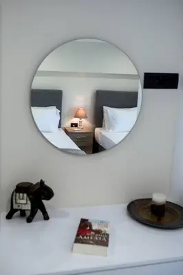 a mirror reflecting a bedroom with a teddy bear on a counter at Home Sweet Home - Big Balcony with Great View in Kissamos