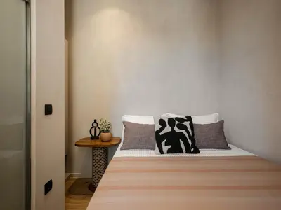 a small bedroom with a bed and a table at Casa Modiano Boutique in Chania Town