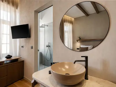a bathroom with a large sink and a mirror at Casa Modiano Boutique in Chania Town