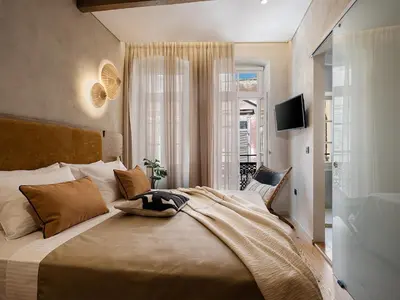 a bedroom with a large bed and a window at Casa Modiano Boutique in Chania Town