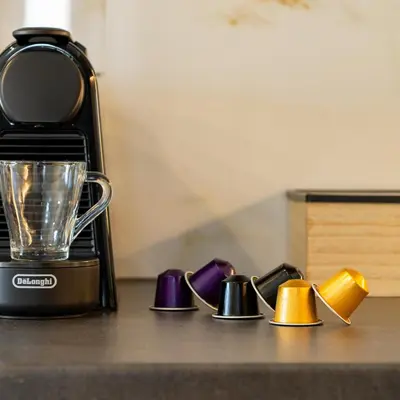 a kitchen counter with a blender and a group of shoes at Ruby Luxury Suites in Chania Town
