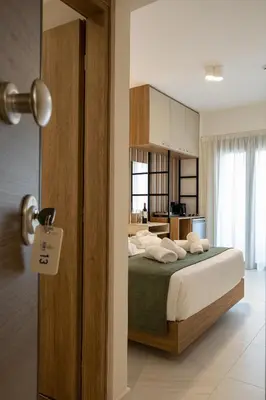 a bedroom with a bed with white pillows on it at Ruby Luxury Suites in Chania Town
