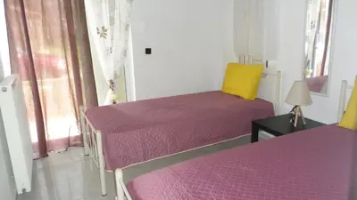 two beds in a room with purple and yellow sheets at Chania Luxury Apartments in Chania Town