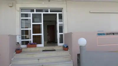 an open door of a house with stairs and flowers at Chania Luxury Apartments in Chania Town