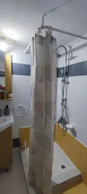 a shower curtain in a bathroom with a sink at Chania Luxury Apartments in Chania Town