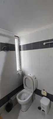 a bathroom with a white toilet and a window at Chania Luxury Apartments in Chania Town
