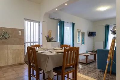 a dining room with a table and chairs at Vasiliki house in Daratso