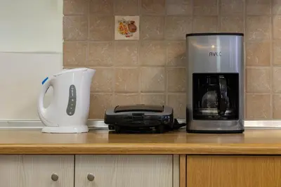 a coffeemaker and a coffee maker on a counter at Vasiliki house in Daratso