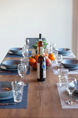 a wooden table with a bottle of wine and glasses at Apokoronas Views Villa in Néon Khoríon