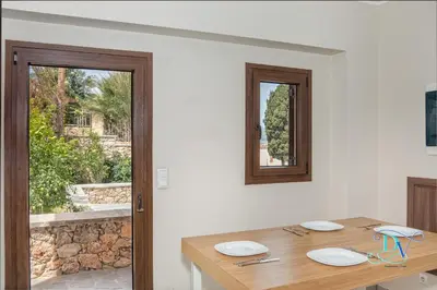 a dining room with a wooden table and a window at Apokoronas Views Villa in Néon Khoríon