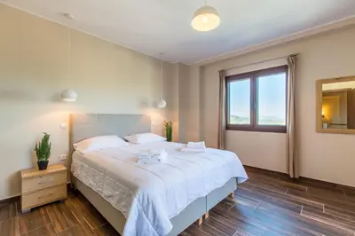 a bedroom with a large bed and a window at Apokoronas Views Villa in Néon Khoríon