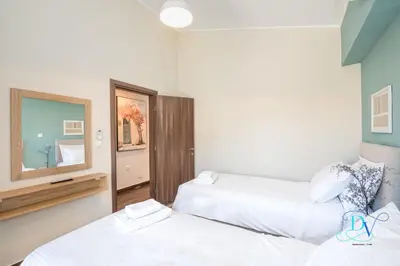 a room with two beds and a mirror at Apokoronas Views Villa in Néon Khoríon