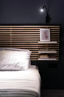 a bedroom with a headboard with a bed and books at Nostos Central Apartment in Chania Town