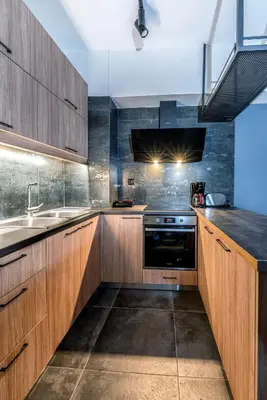a kitchen with wooden cabinets and a sink at Nostos Central Apartment in Chania Town