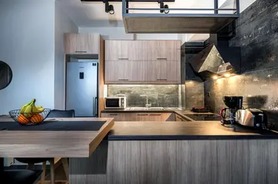 a kitchen with wooden cabinets and a counter top at Nostos Central Apartment in Chania Town