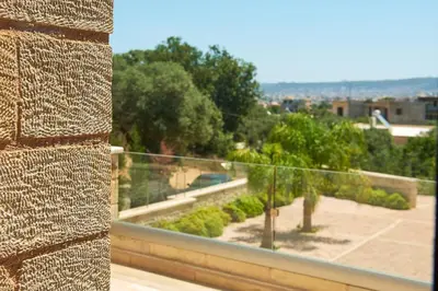 a brick wall with a view of a park at Sunaktis luxury villa in Chania Town