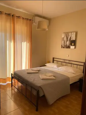 a bedroom with a bed with a towel on it at Koundouros Home in AmigdhalokeFálion
