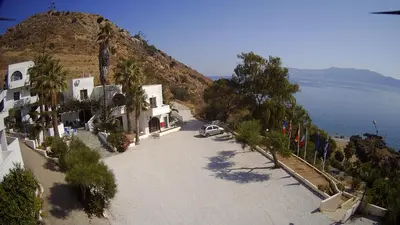an overhead view of a street with a mountain and water at Delfini Apartments in Kissamos