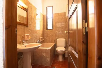 a bathroom with a sink and a toilet and a tub at Delfini Apartments in Kissamos