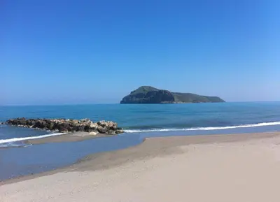 an island in the ocean with a sandy beach at Ermis Suites in Plataniás