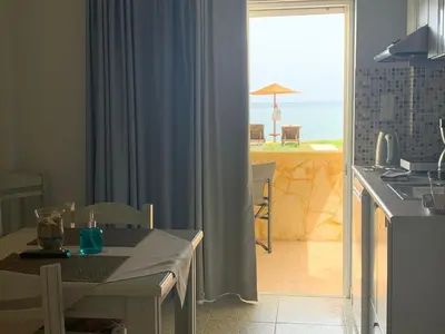 a kitchen with a table and a view of the ocean at Ermis Suites in Plataniás