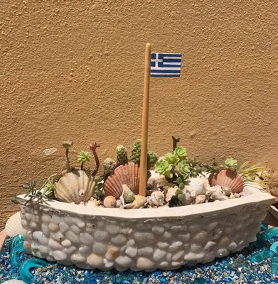 a pot of plants with a flag in it at Ermis Suites in Plataniás