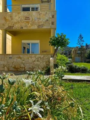 a house with a garden in front of it at Ermis Suites in Plataniás
