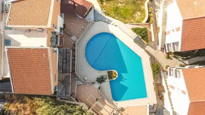 an overhead view of a swimming pool in front of buildings at Chrispy Waterpark Resort - All inclusive in Kolymvari