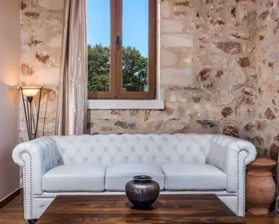a white couch in a living room with a window at Villa Malaxa Private Luxury with Amazing View in Maláxa