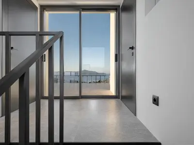 an open door to a balcony with a view of the beach at Brand new Villa Eleftheria BY APOKORONAS-VILLAS in Plaka