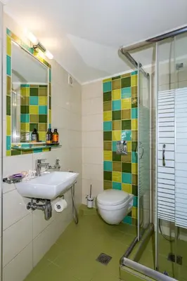a bathroom with a sink and a toilet and a shower at Aris Boutique Hotel in Palaiochóra
