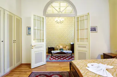 a bedroom with two beds and an open door at Halepa Hotel in Chania Town